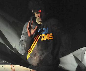 Dramatic photos taken by Massachusetts State Police Sgt. Sean Murphy of Dzhokhar Tsarnaev as he was captured from the boat he was hiding out in Watertown. Photo by Sean P. Murphy via Boston Magazine - Web must link to boston magazine site: http://www.bostonmagazine.com/news/blog/2013/07/18/tsarnaev/ .