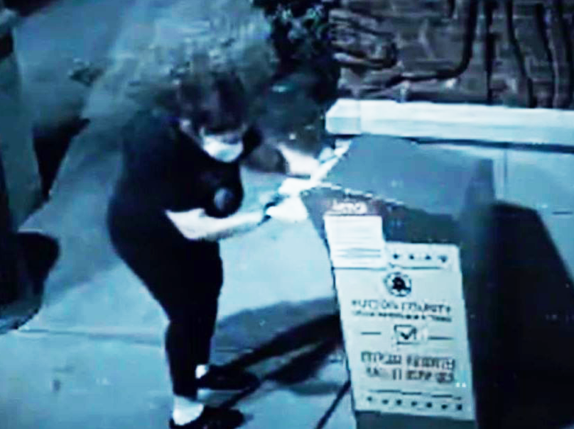 A lady inserts some ballots into the ballot box