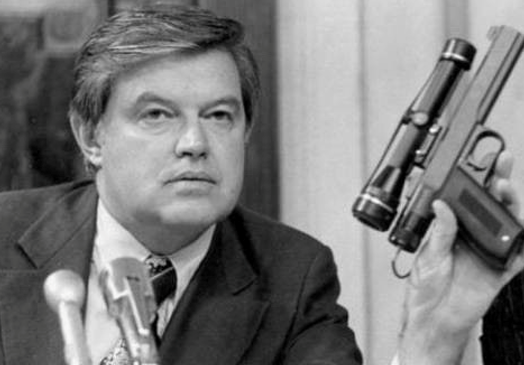 Sen Frank Church shows off the CIA gun